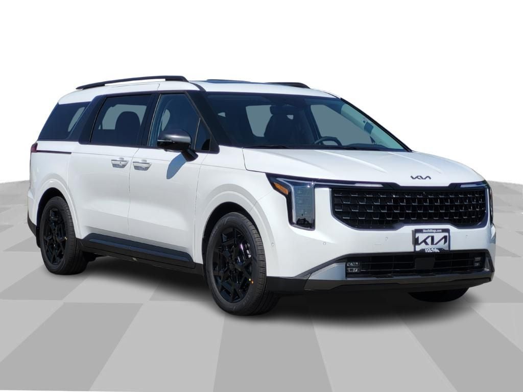 2026 Kia Carnival SX Prestige in Snow White Pearl — front three-quarter view